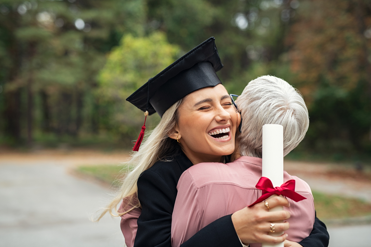 Graduate girl hugging mother